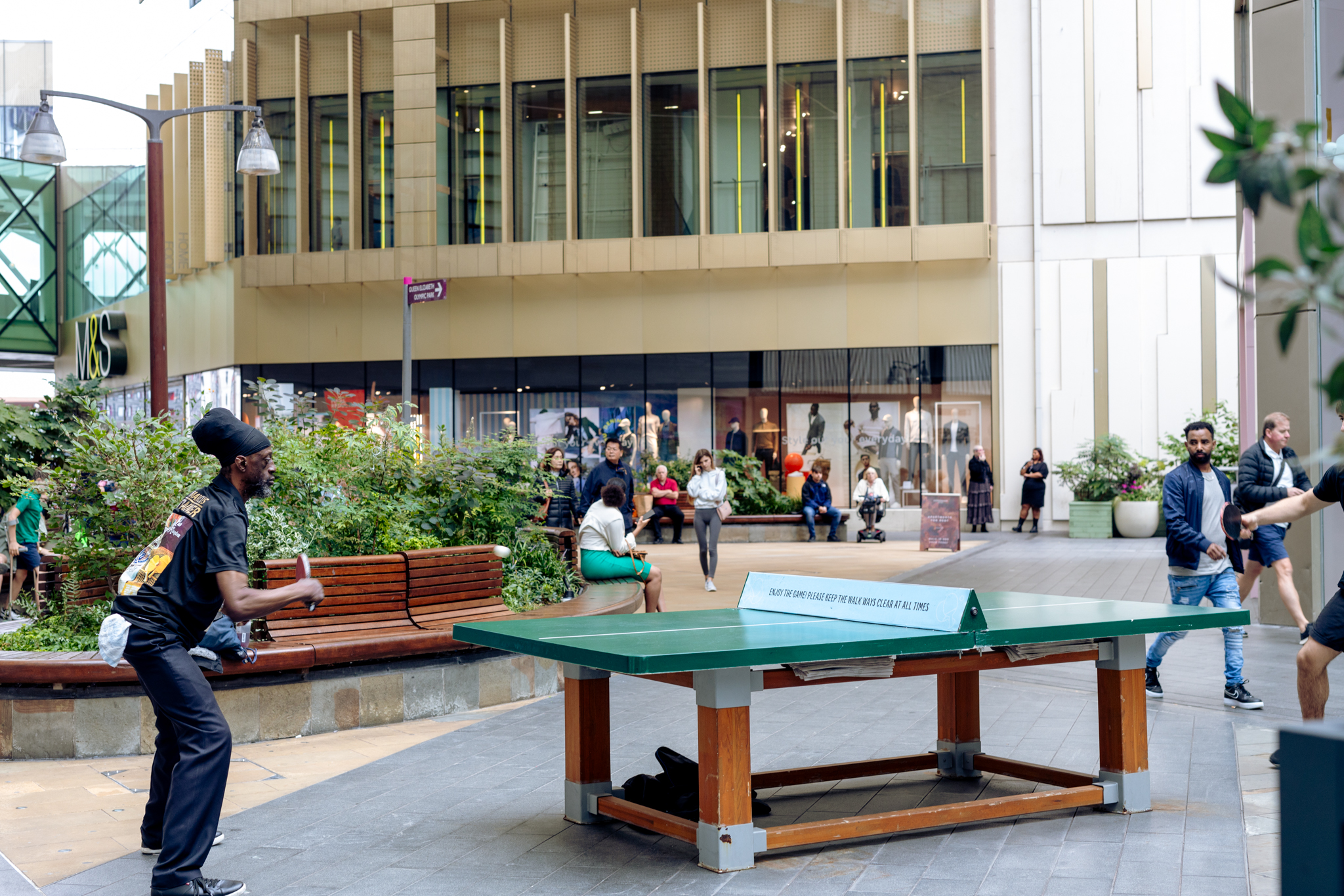 People playing table tennis outside